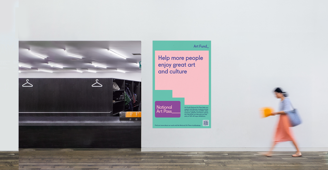 Art Fund 'Help more people enjoy great art and culture' poster on a gallery wall at Tate Modern as a visitor walks past.